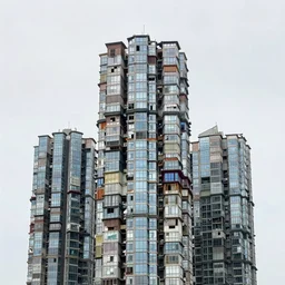 high towers made up of makeshift squatter shacks with glass facades, mamiya, 8 5 mm, uniform plain sky, fine details, photographed by julie blackmon