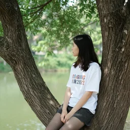 a tree sitting in a girl wearing a tshirt