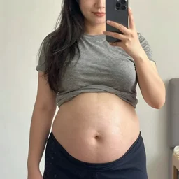 a full - body selfie of sommer ray with an extremely round and distended chubby belly, focus on!!!!!! facial details!!!!!!, focus on her belly fat pressing against her clothes, instagram post, 8 k resolution