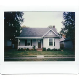 a polaroid photograph of a 2 0 0 0 s house,