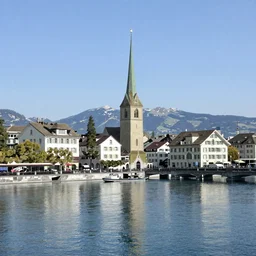 Photo of Zurich, looking down the river at the lake and the alps, Hardturm, Grossmünster, wide angle, trees, volumetric light, hyperdetailed, caribean water, artstation, cgsociety, 8k