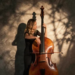 Lindsey Stirling playing a double bass