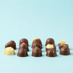 chocolate confectioneris of various colors and shapes arranged on a table, food photography, blue pastel background, studio lighting