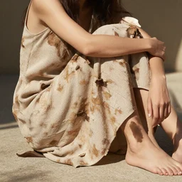 woman sits sunlit dried caked bleached