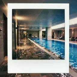 a flooded hotel hallway leading to an indoor pool, polaroid, liminal space, surreal,