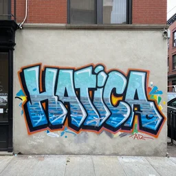 a grafitti that reads hatica on a new york wall, hyper realistic