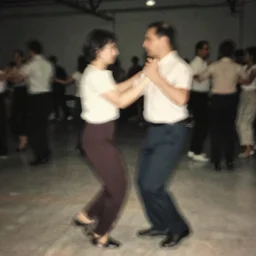 a smudged, grainy and blurry photograph of two men dancing, taken with soviet flash camera at slow shutter speed