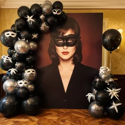 a gender reveal party using the design theme of the masked ball scene from the movie eyes wide shut