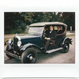 polaroid photo of the first ever car produced with people sitting inside of it wearing 1800s clothing.