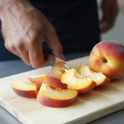 sliced peaches on a cutting board by nicolas delort and moebius