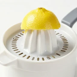 juicing a lemon on a lemon juicer, close up photo