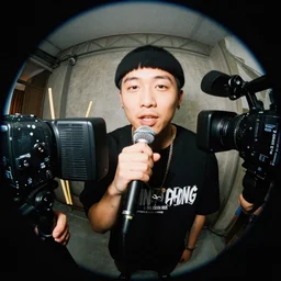 I GOT THAT CHING CHANG CHONG THE ONE WITH CHOP STICK OH I GOT THAT CHIN CHANG CHONG (CHING CHANG CHONG), Chinese rapper holding a microphone infront of an fish eye lense camera, VHS, Camcorder, Realism,