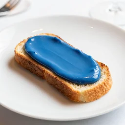 elegant fancy food photography of dish consisting of a toast with blue liquid spread over it in a michelin star restaurant,