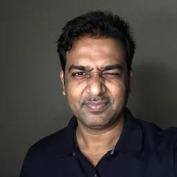 my indian dad taking a selfie in the dark and squinting his eyes because the camera flash is too bright