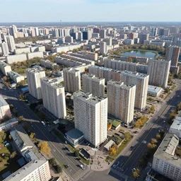 bird's eye view photograph of a highrise Russian city, apartments, train station, pond, wide roads