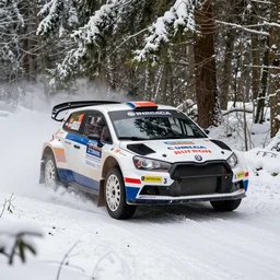 a 1 9 8 2 lancia 0 3 7 stradale, racing through a rally stage in a snowy forest
