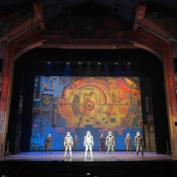 photo of a huge theaterstage, play is starwars, 3 actors on stage, 8 k, multicolored, exaggerated detailed, long shot