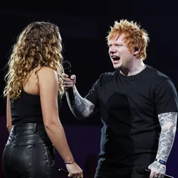 Ed Sheeran angry and shouting at a girl fan climbing onto the stage with him