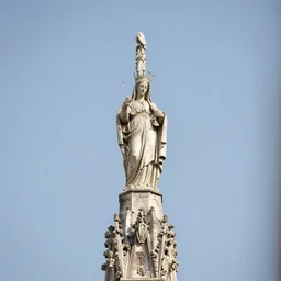 the holy mother statue on top of the milan cathedral