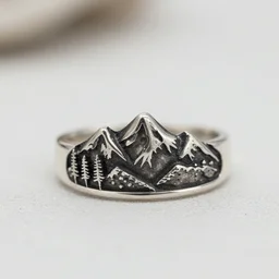 a silver ring design inspired on mountains and nature, bohemian style, macro photography