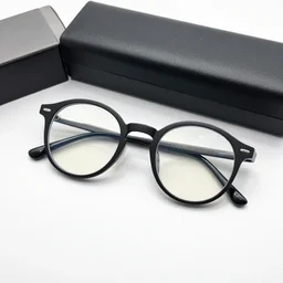 a black colored circular glasses on a glasses box