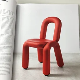 a chair designed by jeff koons, interior design magazine photography