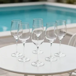 5 5 mm photo of best wine glass on a zen minimalist white table with luxury pool in the background. highly detailed 8 k. intricate. lifelike. soft light,