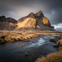 award winning landscape photography of iceland by andy lee, river in foreground with epic mountain in sunlight in background, beautiful light, moody, long exposure, infrared photography, ir filter, dramatic lighting, clouds, rule of thirds, golden ratio