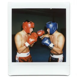 square polaroid photo of two boxers with 1 9 2 0 s hats fighting, body worlds,