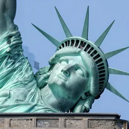 statue of libertys head lying sideways with crown is broken off