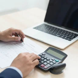 business accounting concept, business man using calculator with computer laptop, budget and loan paper in office, photorealistic