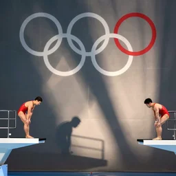 xi jinping and kim jong un focusing before their synchronized dive at the olympics